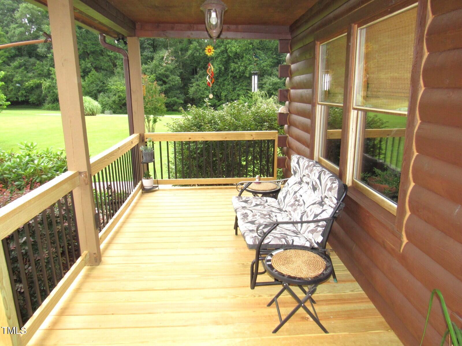 1159 Flemingtown Road Henderson, NC 27537 - Photo 42 of 51 a balcony with furniture and wooden floor