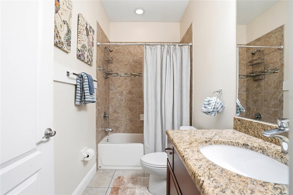2906 West Douglas Street Tampa, FL 33607 - Photo 23 of 36 a bathroom with a granite countertop sink toilet and shower