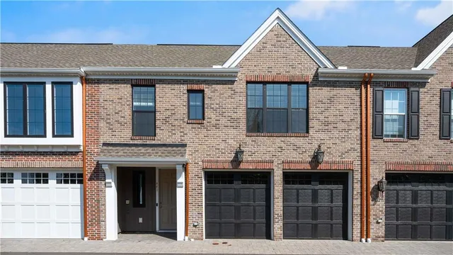 a view of a brick house with large windows