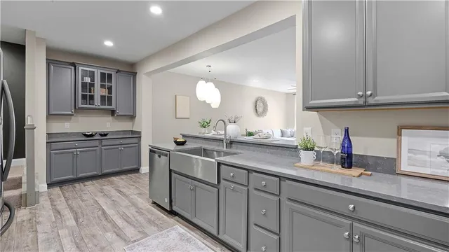 a kitchen with a sink appliances and cabinets
