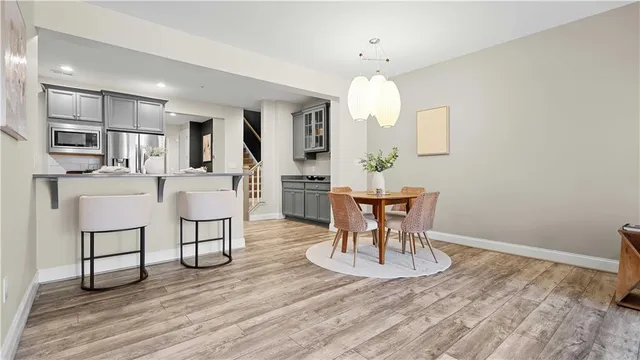 a living room with furniture wooden floor and a large window