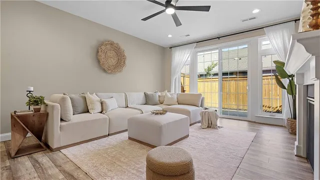 a living room with furniture and a wooden floor