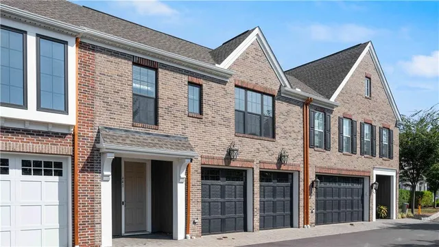 a view of a brick house with large windows