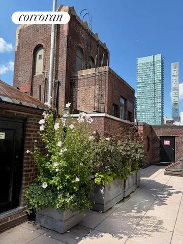 a building outdoor space with patio furniture and potted plants