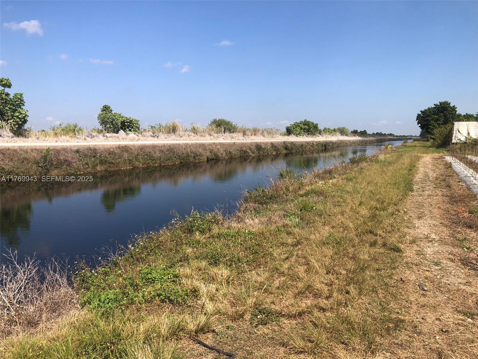 19550 Southwest 207th Avenue Miami, FL 33187 - Photo 7 of 9 a view of a lake with houses in the back