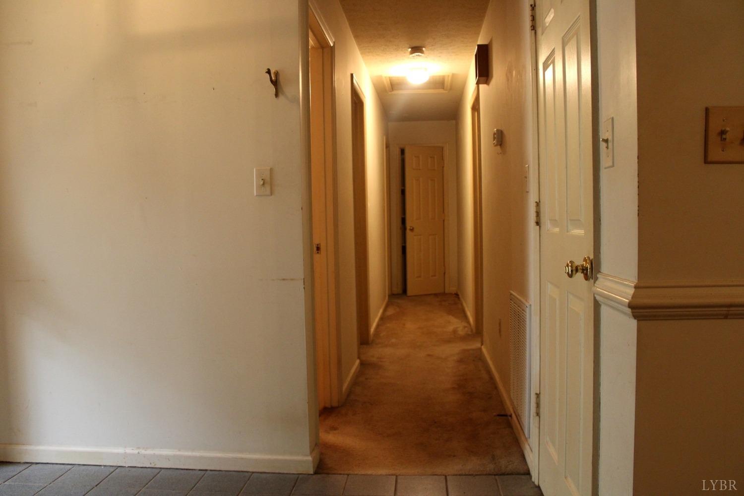 3260 West Perch Road Monroe, VA 24574 - Photo 6 of 12 a view of a hallway with wooden floor
