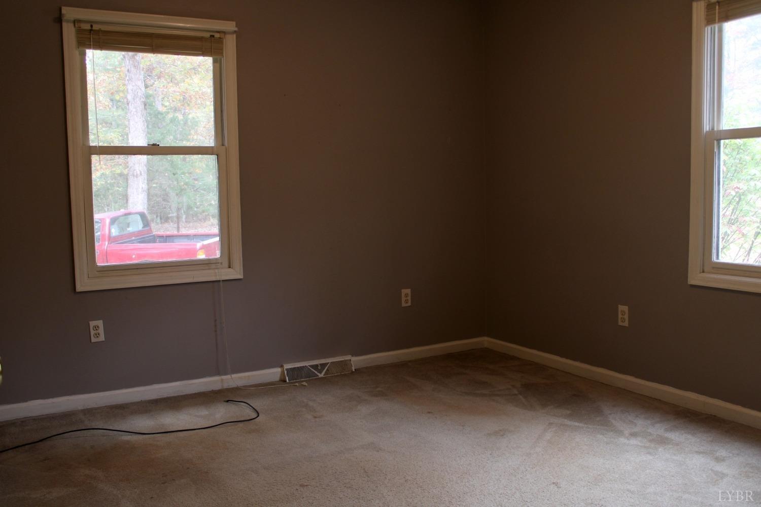 3260 West Perch Road Monroe, VA 24574 - Photo 9 of 12 an empty room with a window