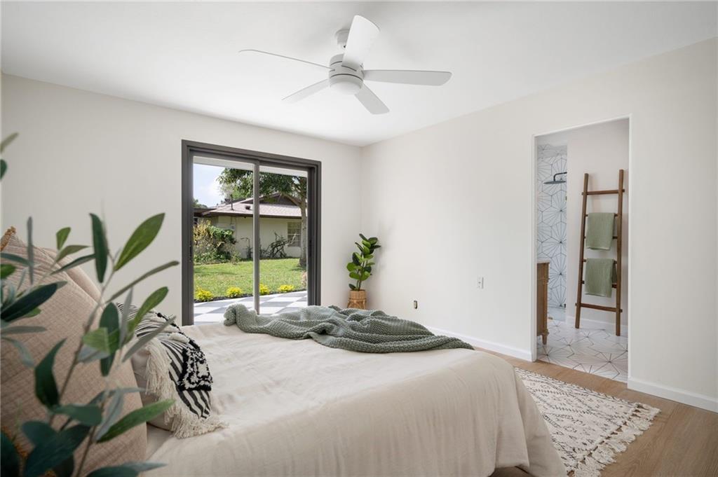 2575 15th Street Vero Beach, FL 32960 - Photo 18 of 36 a bedroom with a bed and a large window