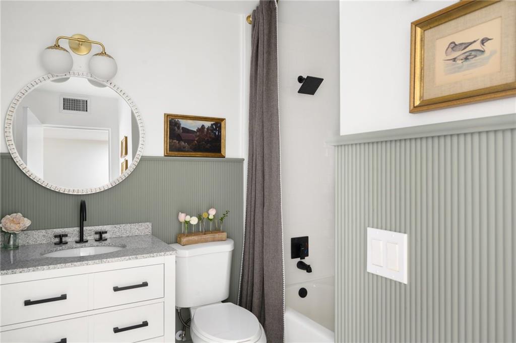 2575 15th Street Vero Beach, FL 32960 - Photo 9 of 36 a bathroom with a toilet a sink and mirror