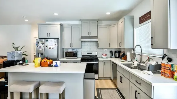 a kitchen with a sink cabinets and refrigerator