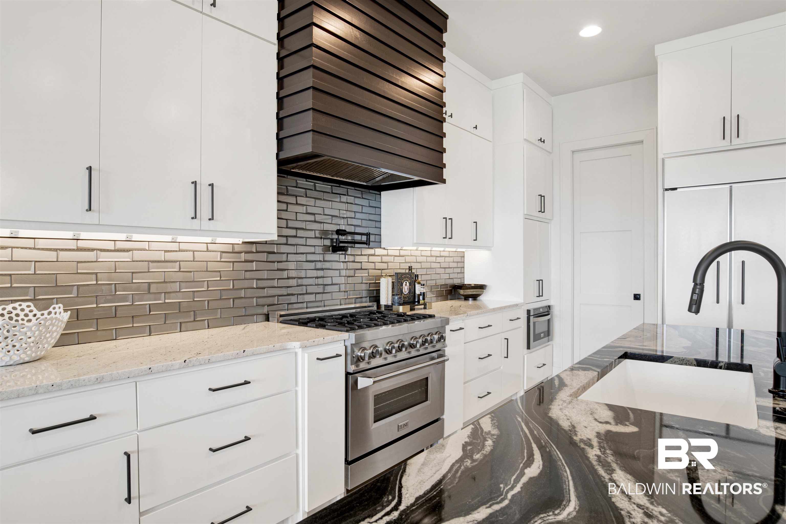 30239 Canal Court Orange Beach, AL 36561 - Photo 21 of 70 Kitchen with white cabinets, dark stone counters, custom exhaust hood, stainless steel appliances, and recessed lighting