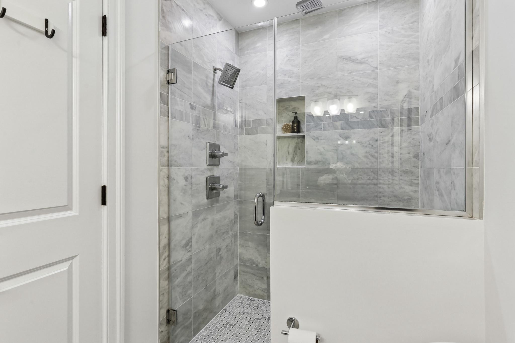 1311 K Street Southeast, Unit 1 Washington, DC 20003 - Photo 16 of 33 Sleek modern shower with marble surround.