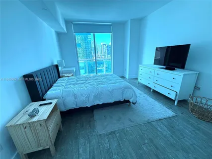 a bathroom with a granite countertop sink mirror and a toilet