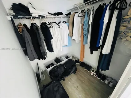 a view of a balcony with chairs and wooden fence