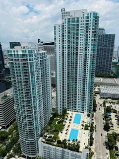 a view of swimming pool with chairs and tables