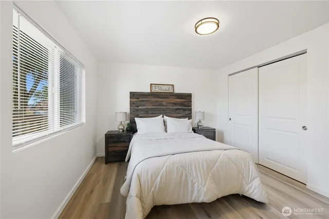 a bedroom with a bed and a window