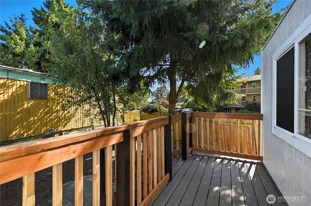 a view of wooden balcony and trees