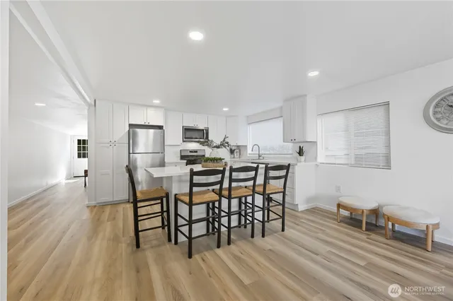 a view of a dining room with furniture and wooden floor