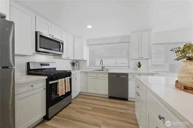 a kitchen with a sink stove and microwave