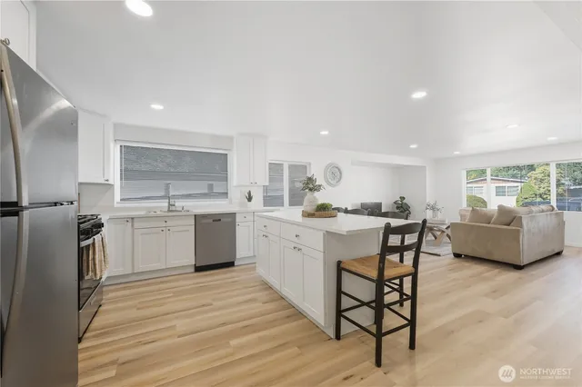a kitchen with a sink cabinets and wooden floor
