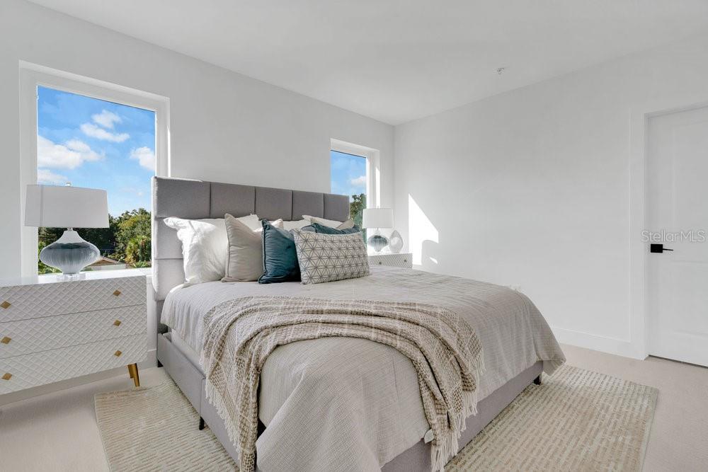 1008 East Robinson Street Orlando, FL 32801 - Photo 13 of 40 a large bed sitting in a bedroom next to a window