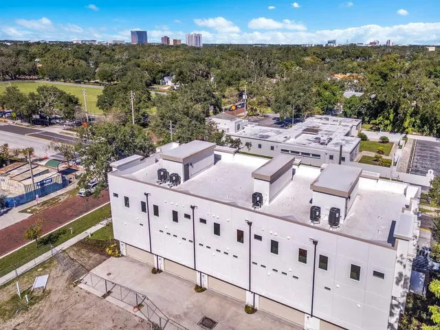 a view of a swimming pool with outdoor seating