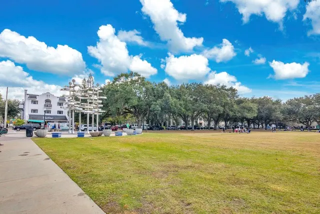 a view of a park with iron fence