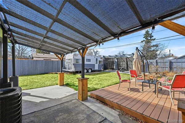 a view of a house with backyard porch and sitting area