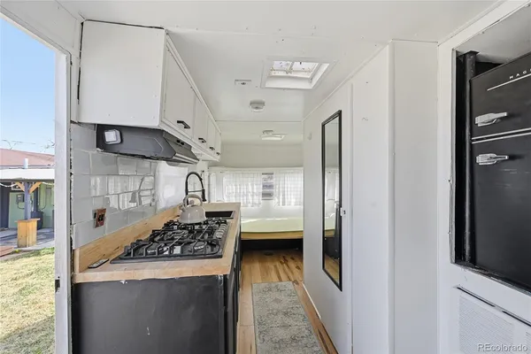 a kitchen with kitchen island a white stove top oven and sink