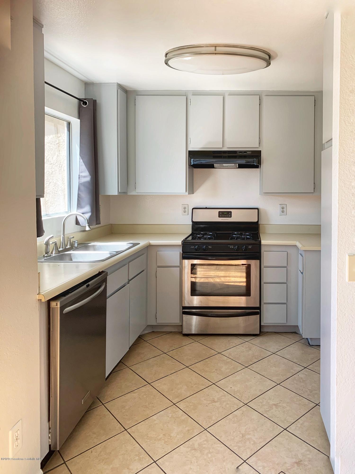 10245 Chaparral Way, Unit E Rancho Cucamonga, CA 91730 - Photo 4 of 31 a kitchen with a stove and a sink