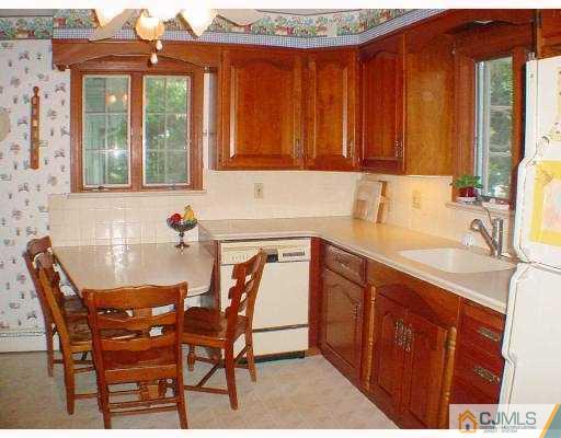 397 Chain O' Hills Road Colonia, NJ 07067 - Photo 6 of 10 a view of a kitchen with granite countertop a sink and cabinets