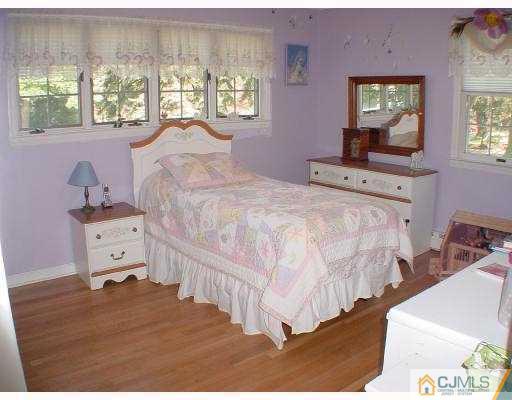 397 Chain O' Hills Road Colonia, NJ 07067 - Photo 8 of 10 a bedroom with a bed and wooden floor