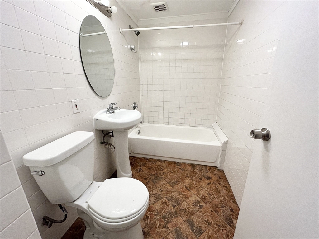 1 Folsom Avenue, Unit 2 Boston, MA 02120 - Photo 8 of 9 a bathroom with a sink a toilet and a mirror