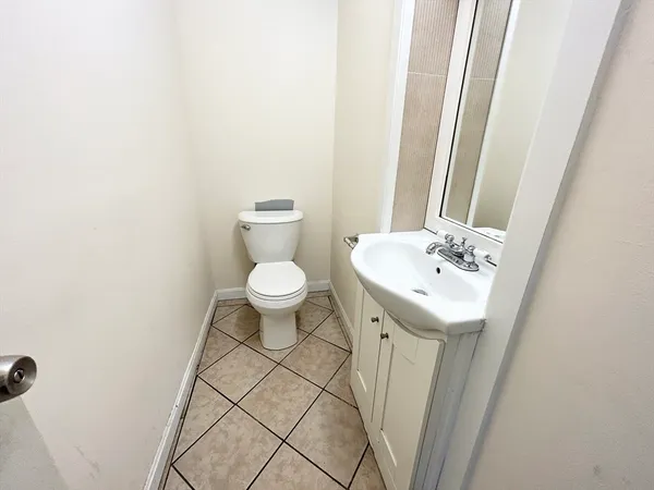 a bathroom with a sink a toilet and a mirror