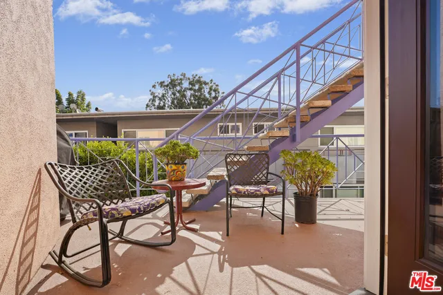 a bedroom with a bed and glass windows