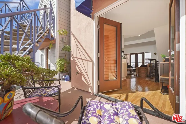 a view of a chairs and table in the balcony