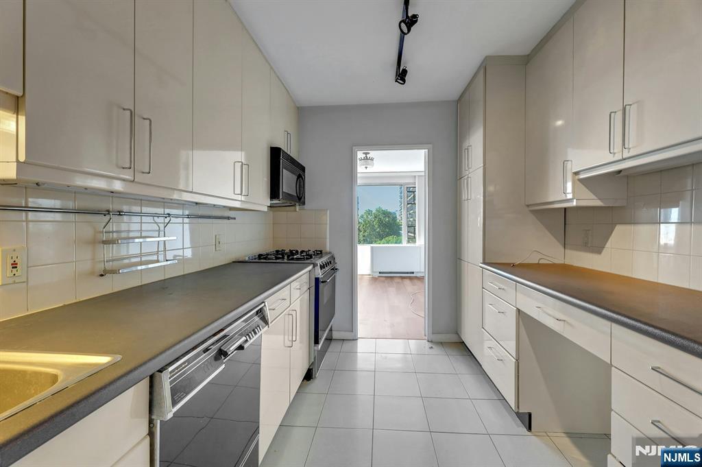 5 Horizon Road, Unit 503 Fort Lee, NJ 07024 - Photo 15 of 45 a kitchen with a sink and a stove top oven