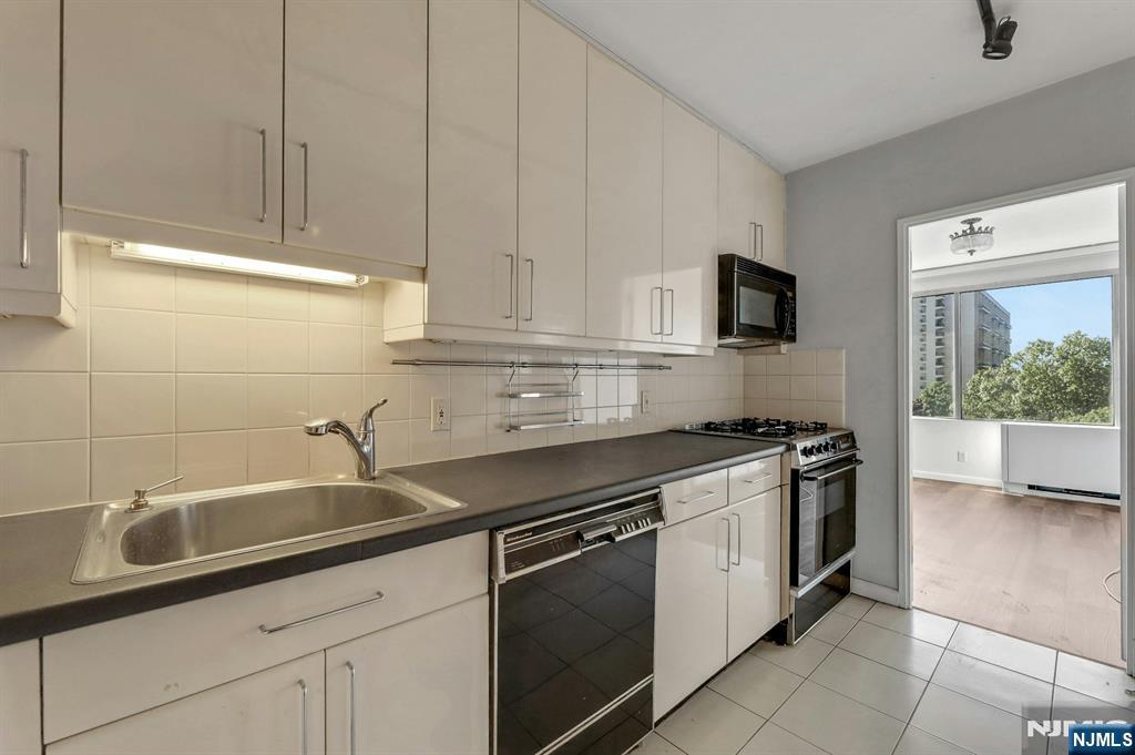 5 Horizon Road, Unit 503 Fort Lee, NJ 07024 - Photo 16 of 45 a kitchen with stainless steel appliances granite countertop a sink stove and microwave