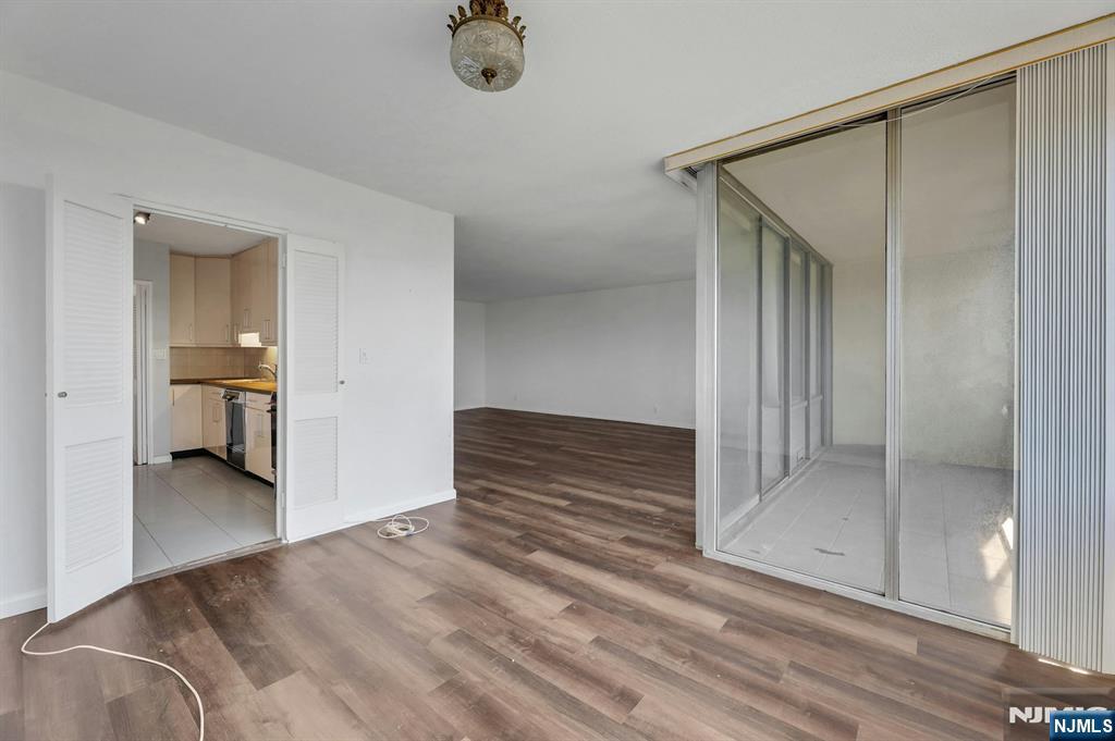 5 Horizon Road, Unit 503 Fort Lee, NJ 07024 - Photo 22 of 45 an empty room with a mirror and a wooden floor
