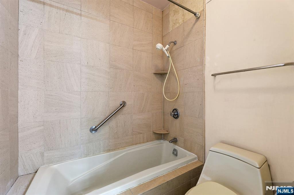 5 Horizon Road, Unit 503 Fort Lee, NJ 07024 - Photo 26 of 45 a bathroom with a bath tub with a shower