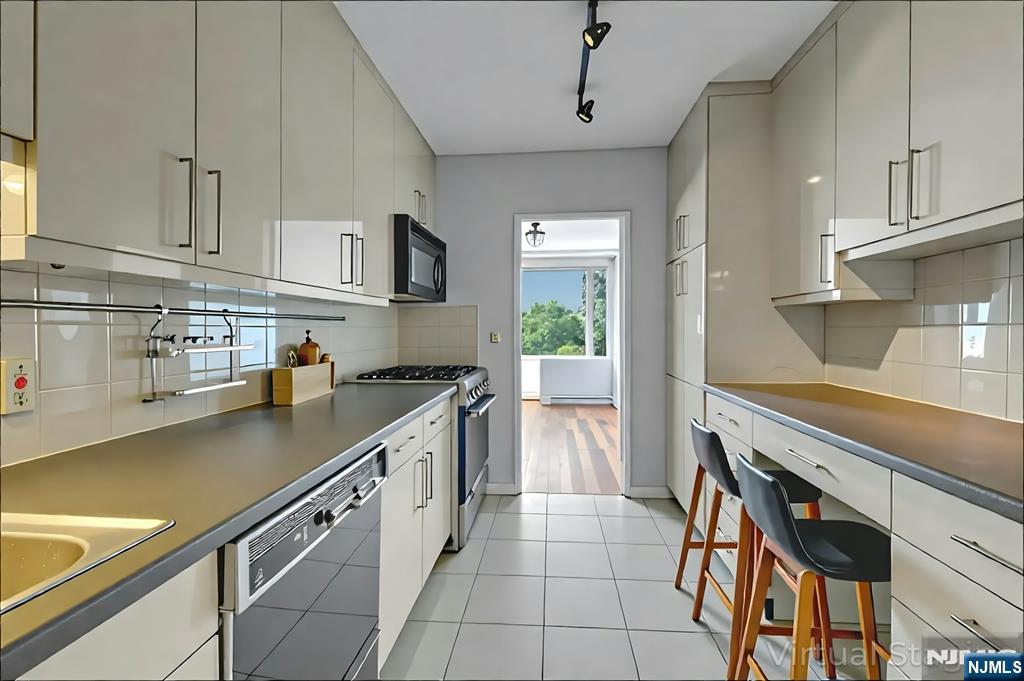 5 Horizon Road, Unit 503 Fort Lee, NJ 07024 - Photo 7 of 45 a kitchen with a sink appliances and cabinets