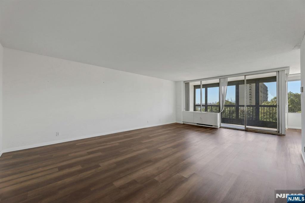 5 Horizon Road, Unit 503 Fort Lee, NJ 07024 - Photo 8 of 45 a view of an empty room with wooden floor and a window