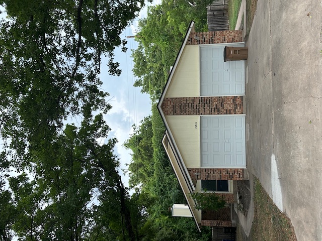 12816 Tomanet Trail, Unit B Austin, TX 78727 - Photo 1 of 1 a front view of house with yard and trees in the background