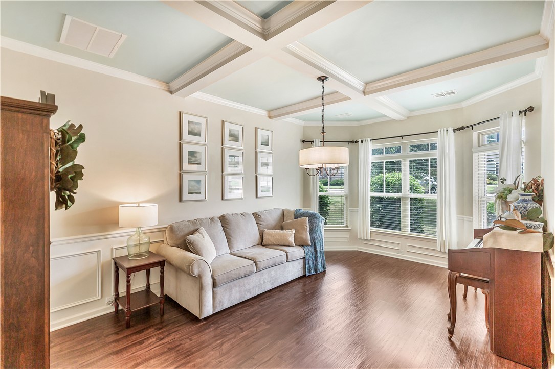 144 Buckland Drive Anderson, SC 29621 - Photo 43 of 48 Coffered ceilings and abundant natural light enhance this inviting living space with rich hardwood floors.