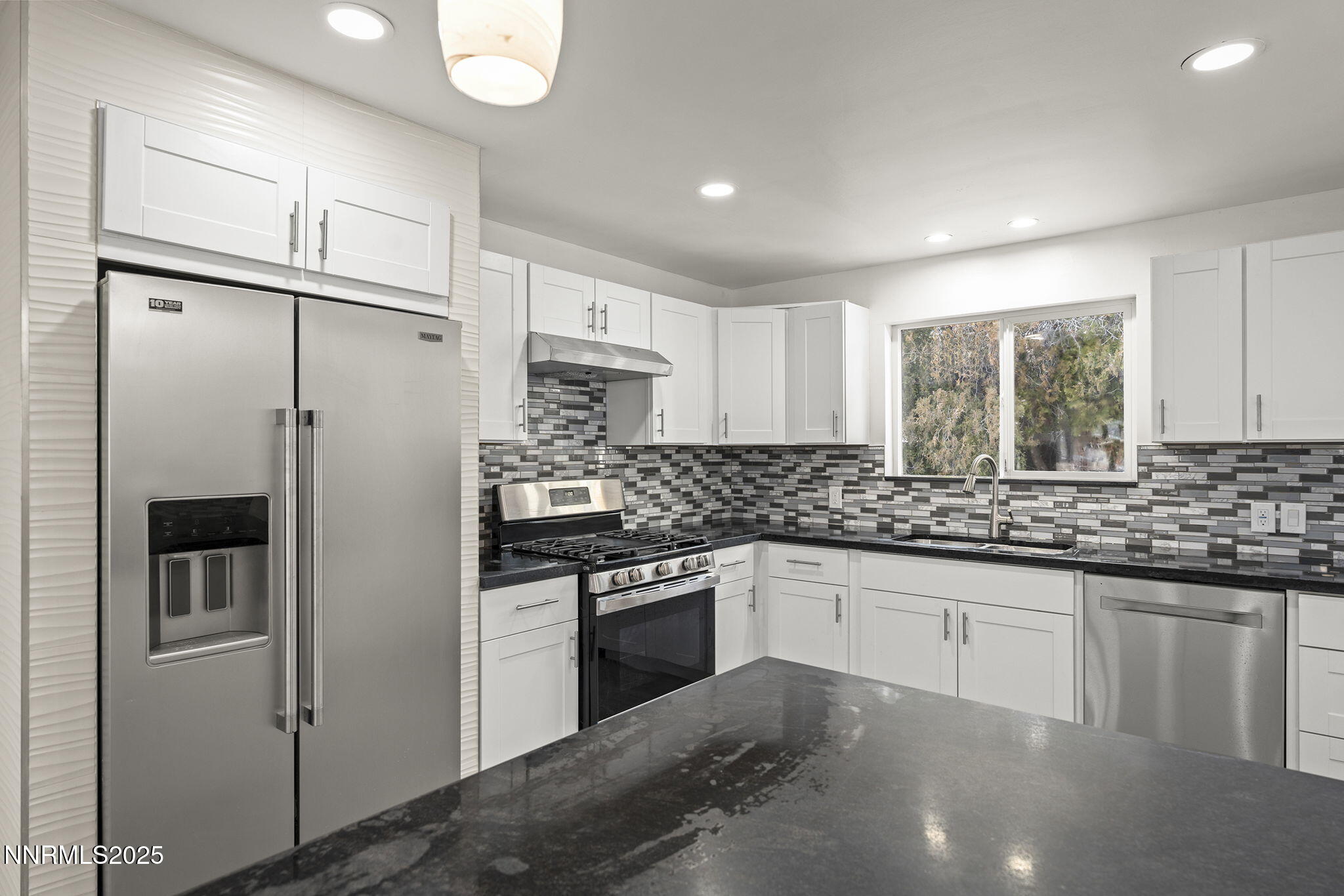 1085 Memory Lane Reno, NV 89509 - Photo 11 of 21 a kitchen with stainless steel appliances granite countertop a refrigerator and a sink