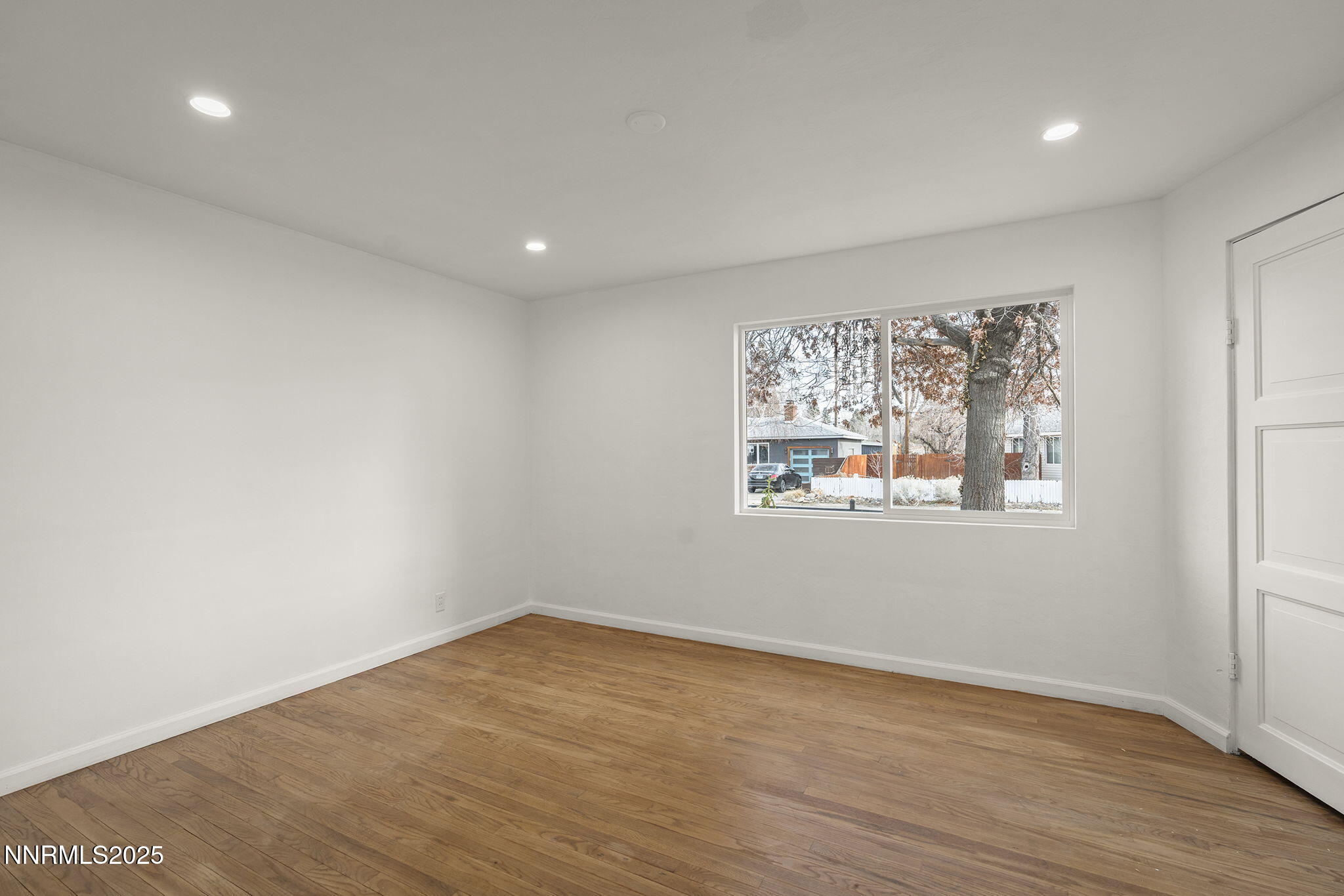 1085 Memory Lane Reno, NV 89509 - Photo 19 of 21 a view of a big room with wooden floor and windows in it