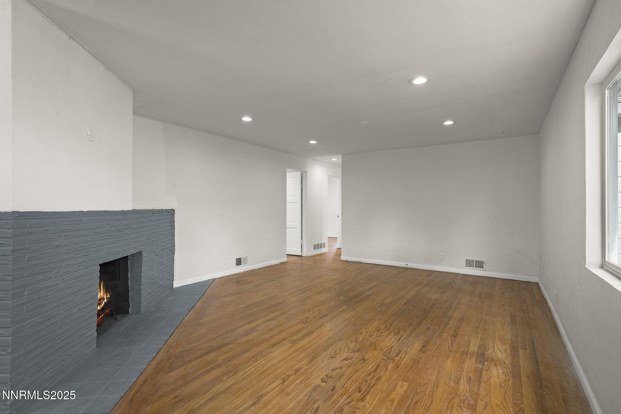 1085 Memory Lane Reno, NV 89509 - Photo 5 of 21 a view of an empty room with wooden floor and a window