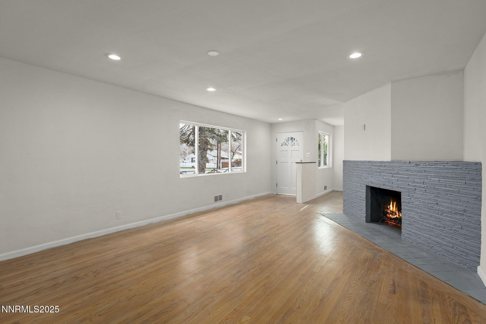 1085 Memory Lane Reno, NV 89509 - Photo 6 of 21 an empty room with windows and fireplace