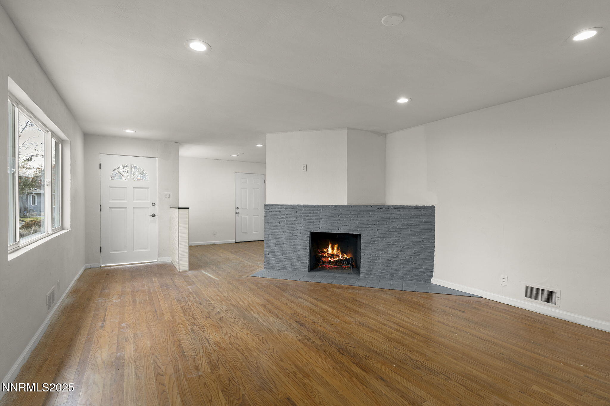 1085 Memory Lane Reno, NV 89509 - Photo 7 of 21 an empty room with a fireplace and window