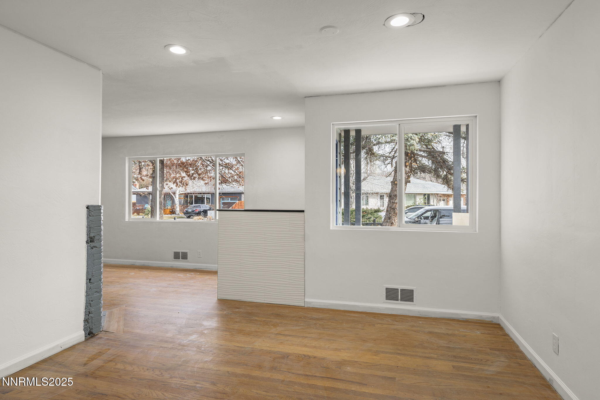 1085 Memory Lane Reno, NV 89509 - Photo 9 of 21 an empty room with wooden floor and windows